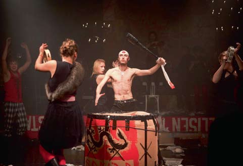 The ensemble of 12 Karamazovia performing amid instruments, blades and theatrical chaos