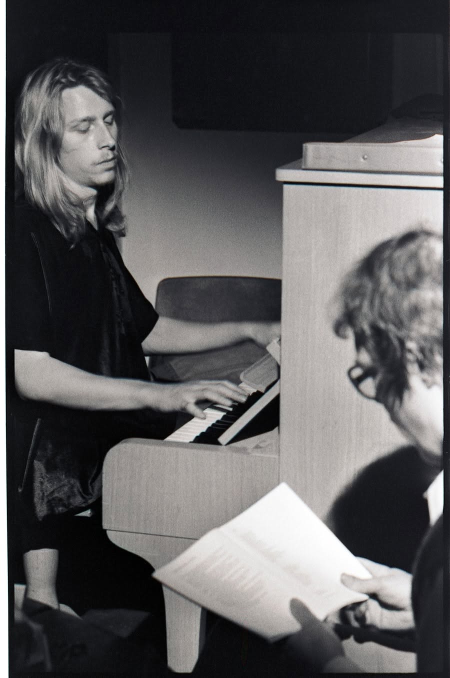 Ismo Laakso at the piano with Markku Into reading